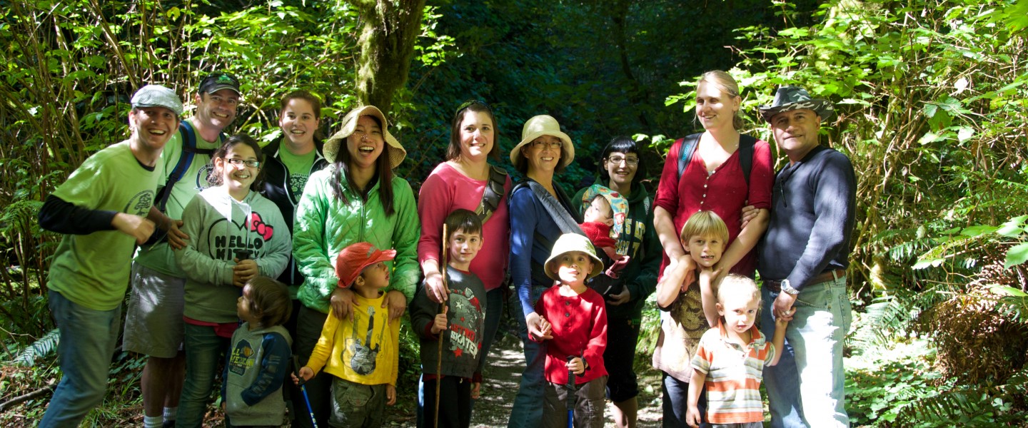 a family taking a group picture outdoors